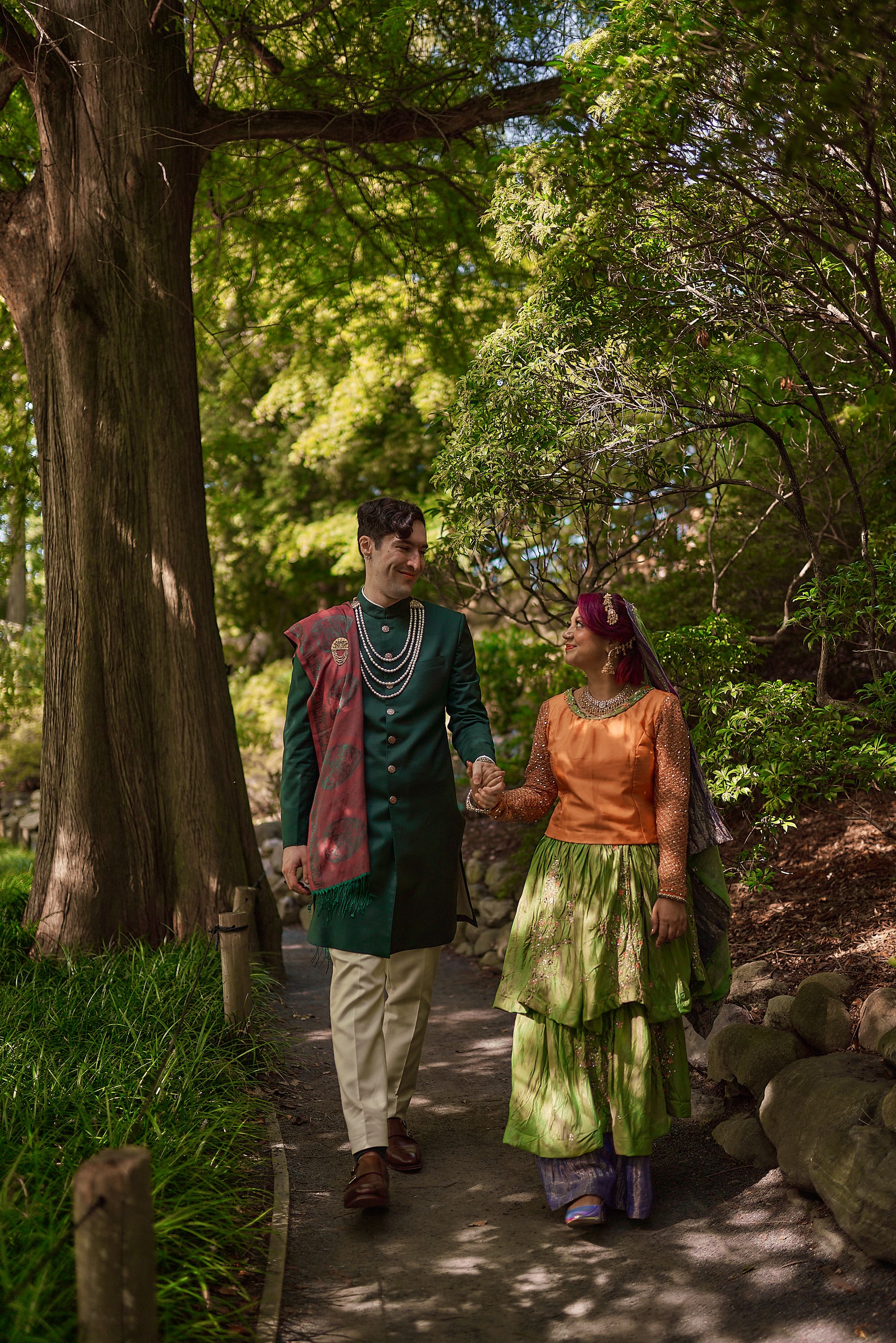 Full length wedding portrait of a couple in traditional South Asian attire